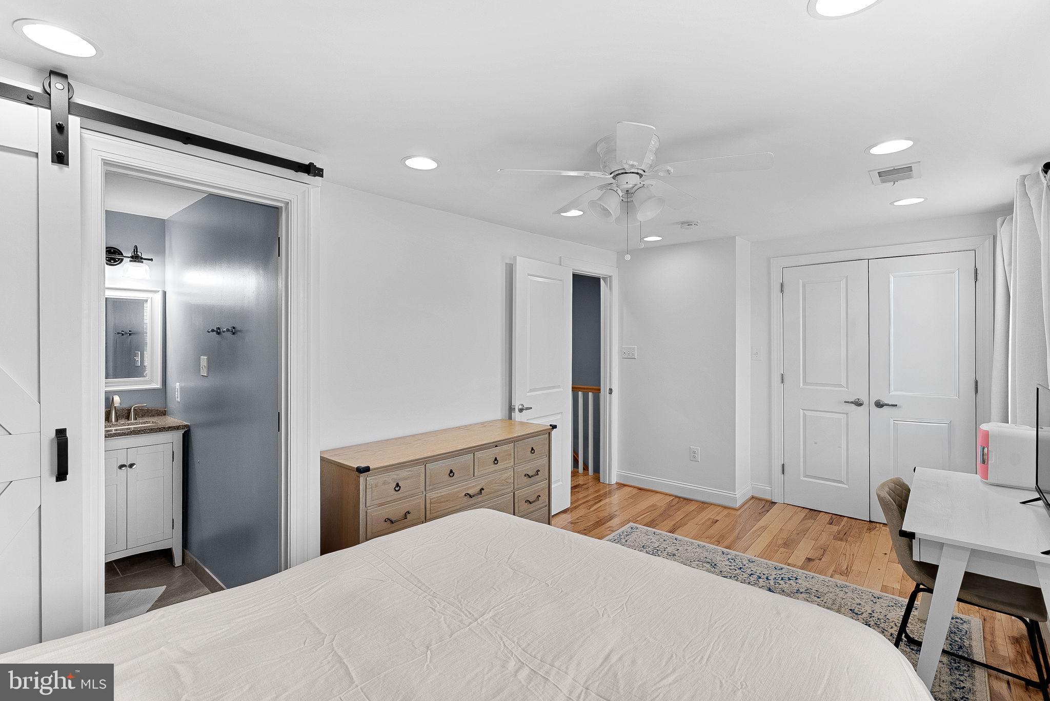 43983 Choptank Terrace Ashburn, VA 20147 - Photo 18 of 43 a spacious bedroom with a bed and a chandelier