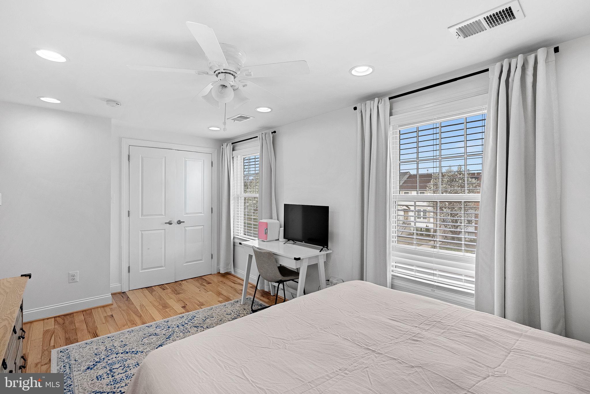 43983 Choptank Terrace Ashburn, VA 20147 - Photo 19 of 43 a bedroom with a bed and a flat screen tv