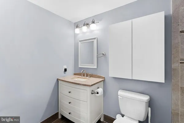 a bathroom with a toilet sink and mirror