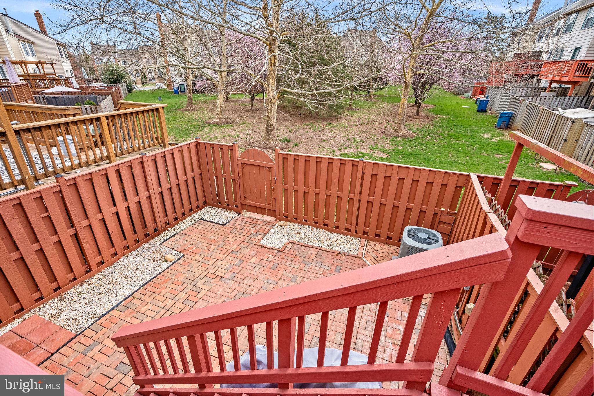43983 Choptank Terrace Ashburn, VA 20147 - Photo 33 of 43 a view of a wooden deck with a yard