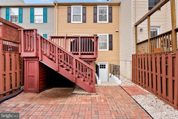a view of a house with wooden deck stairs