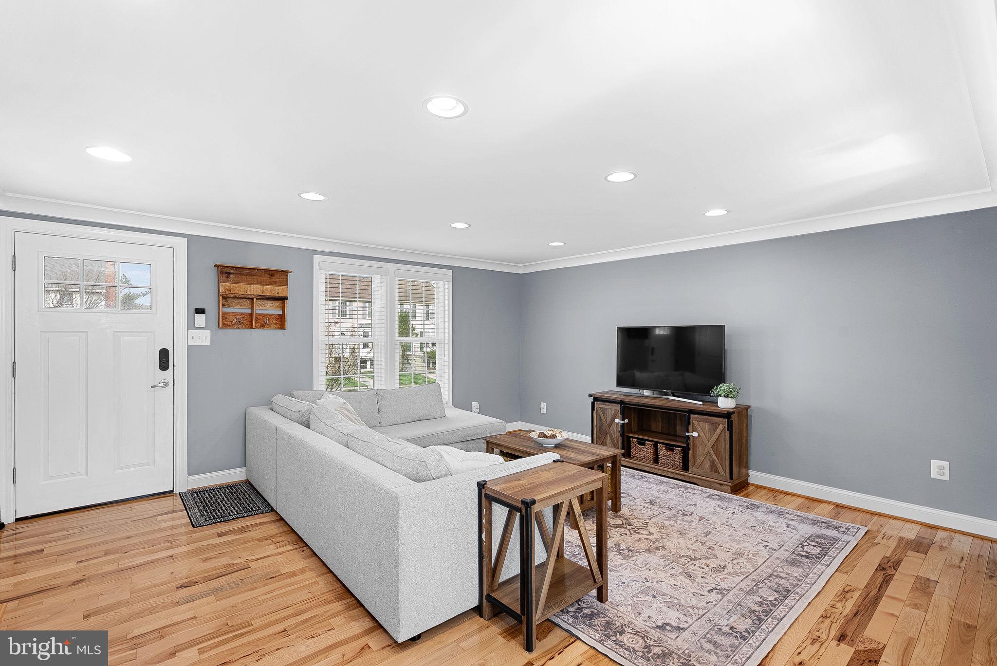 43983 Choptank Terrace Ashburn, VA 20147 - Photo 4 of 43 a living room with furniture and a flat screen tv