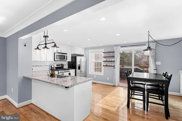 a kitchen with sink cabinets and wooden floor