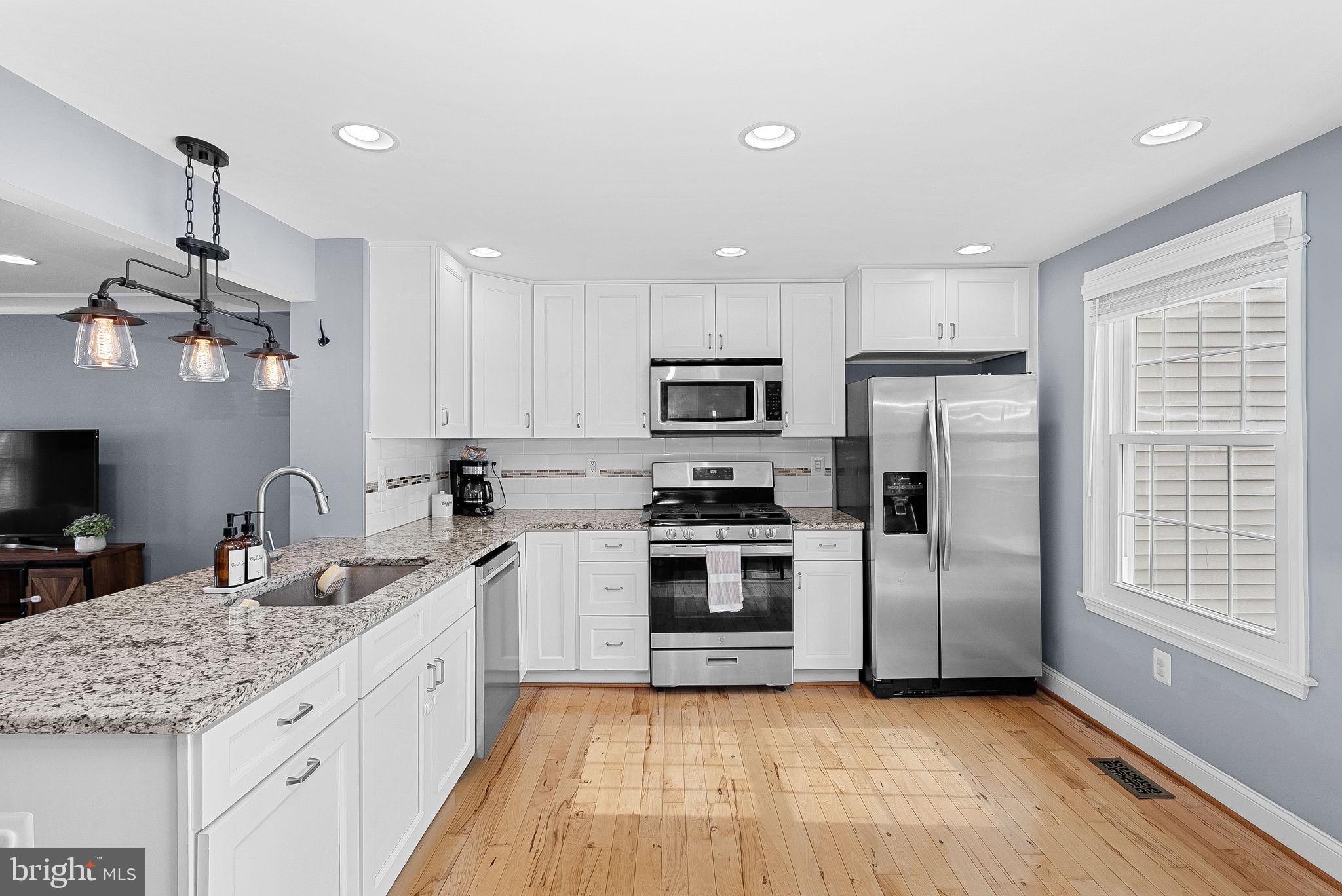 43983 Choptank Terrace Ashburn, VA 20147 - Photo 10 of 43 a kitchen with stainless steel appliances granite countertop a sink stove and refrigerator