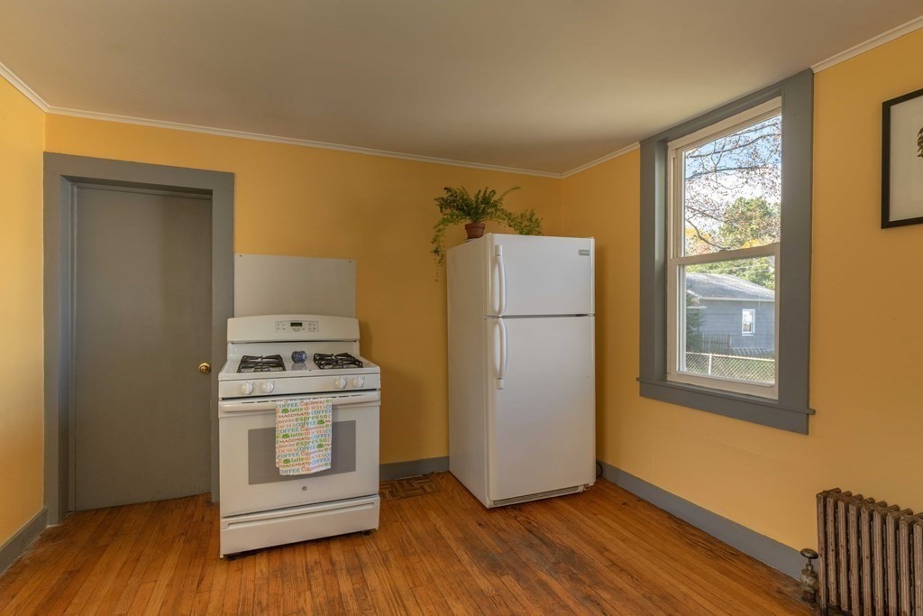 22 Liberty Street Northampton, MA 01062 - Photo 11 of 19 a view of a kitchen with wooden floor and electronic appliances