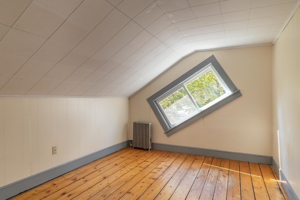 22 Liberty Street Northampton, MA 01062 - Photo 14 of 19 an empty room with wooden floor and windows