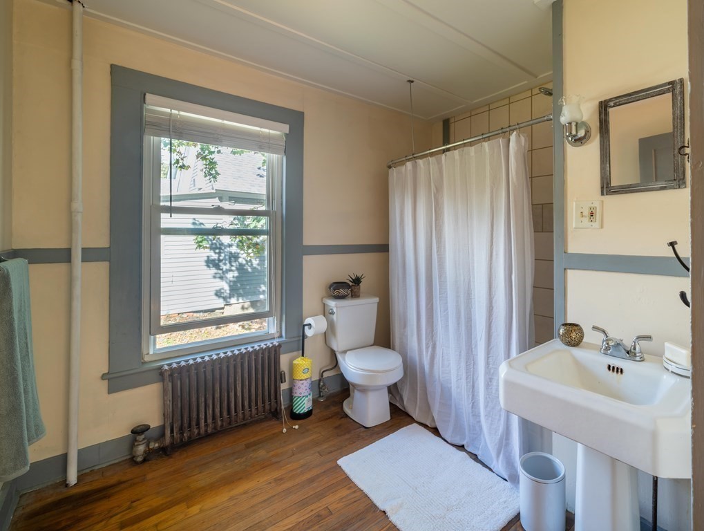 22 Liberty Street Northampton, MA 01062 - Photo 16 of 19 a bathroom with a sink toilet a shower and a window
