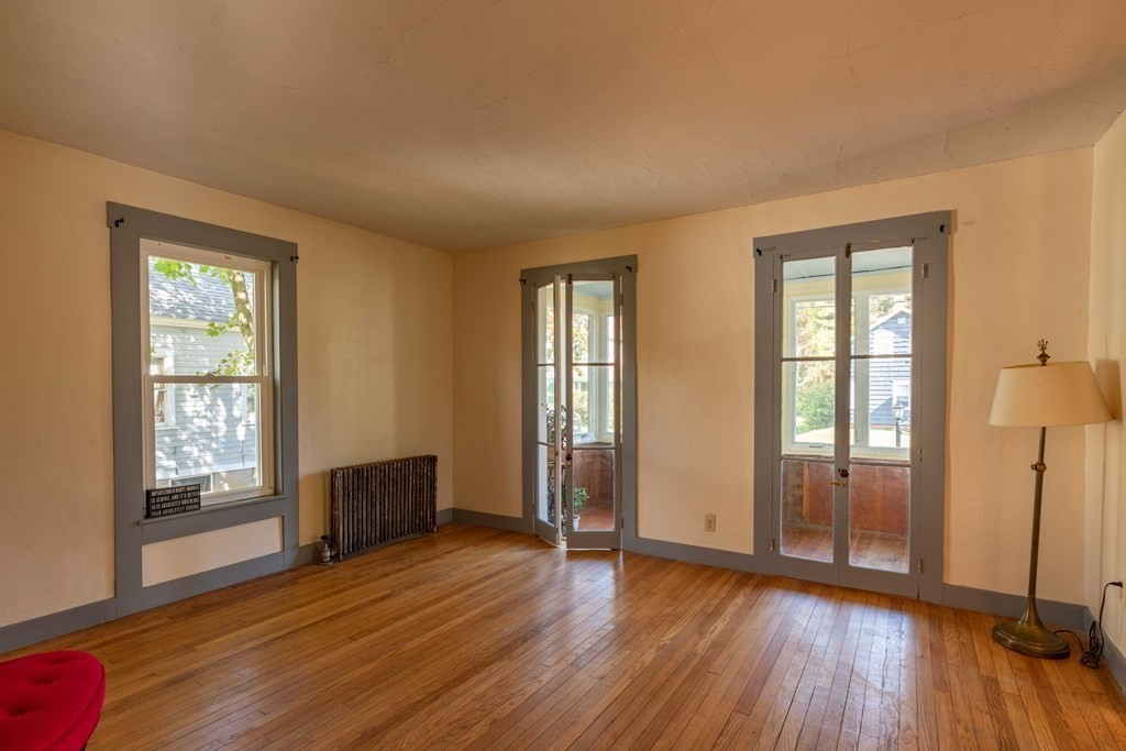 22 Liberty Street Northampton, MA 01062 - Photo 7 of 19 an empty room with wooden floor and windows