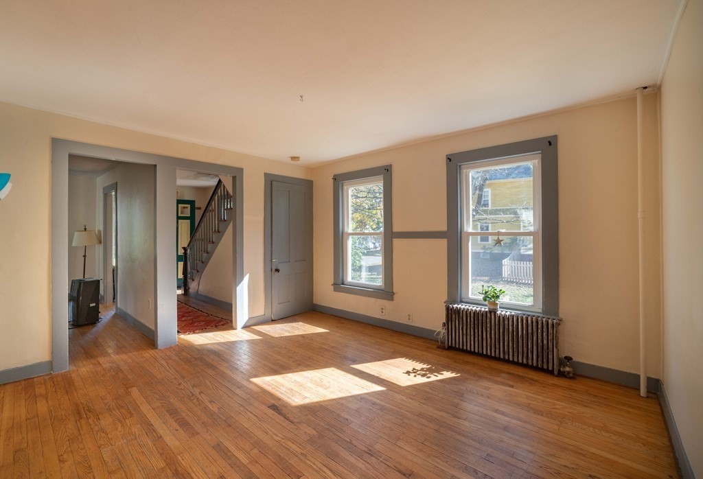 22 Liberty Street Northampton, MA 01062 - Photo 8 of 19 a view of an empty room with wooden floor and a window