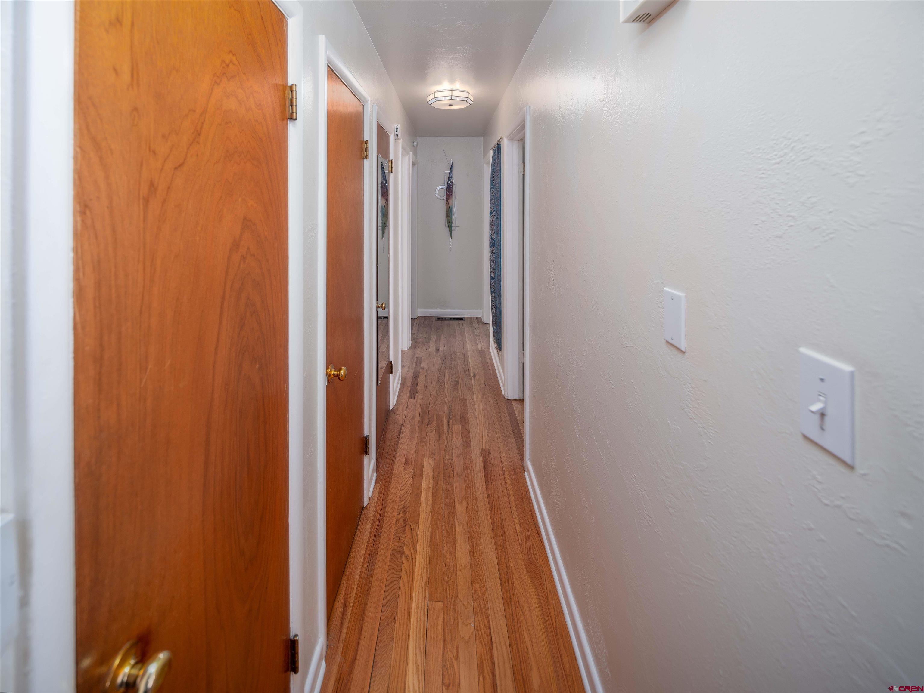 710 Wedgewood Street Cortez, CO 81321 - Photo 14 of 30 a view of a hallway with wooden floor