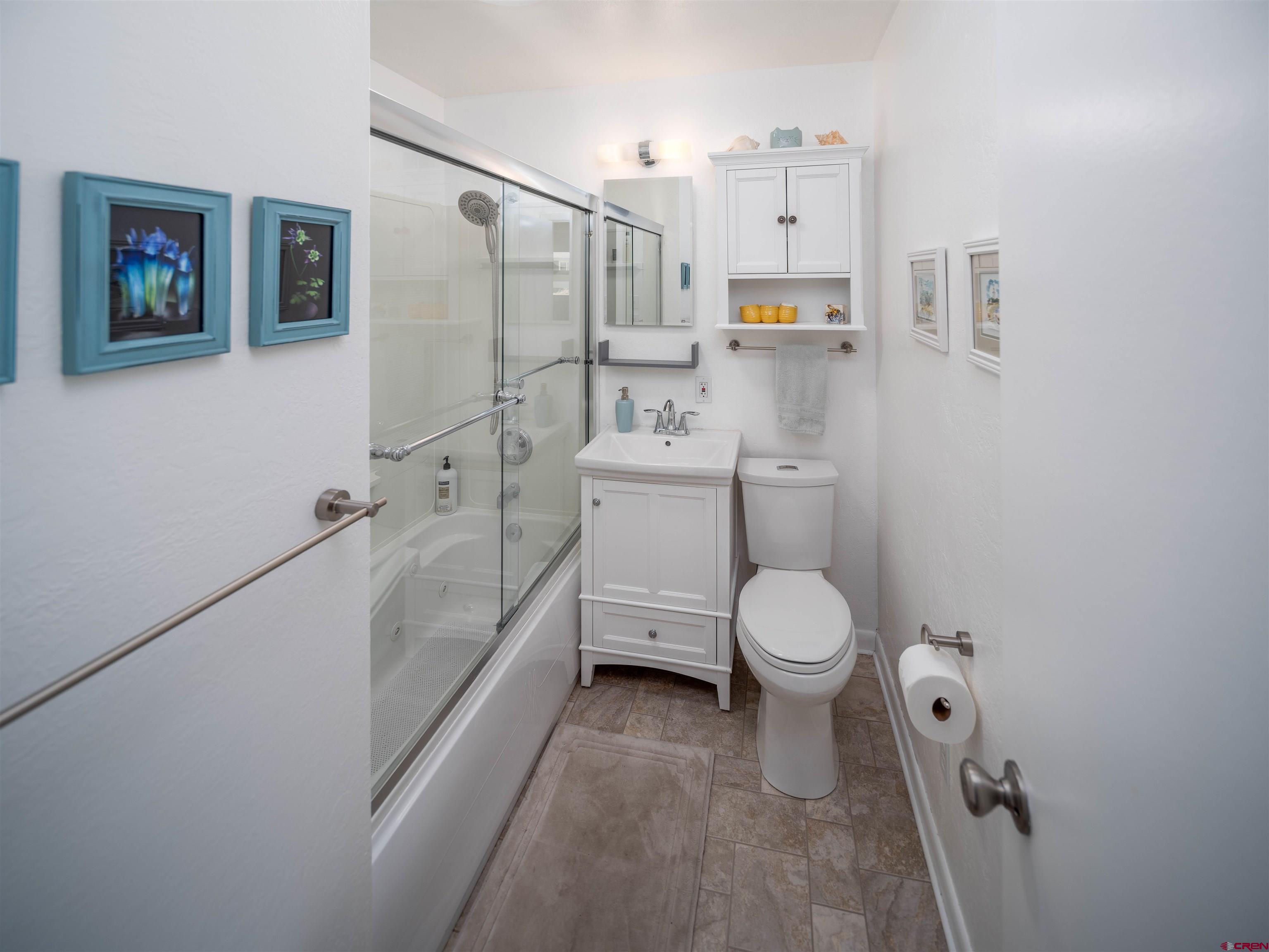 710 Wedgewood Street Cortez, CO 81321 - Photo 16 of 30 a bathroom with a toilet sink and shower
