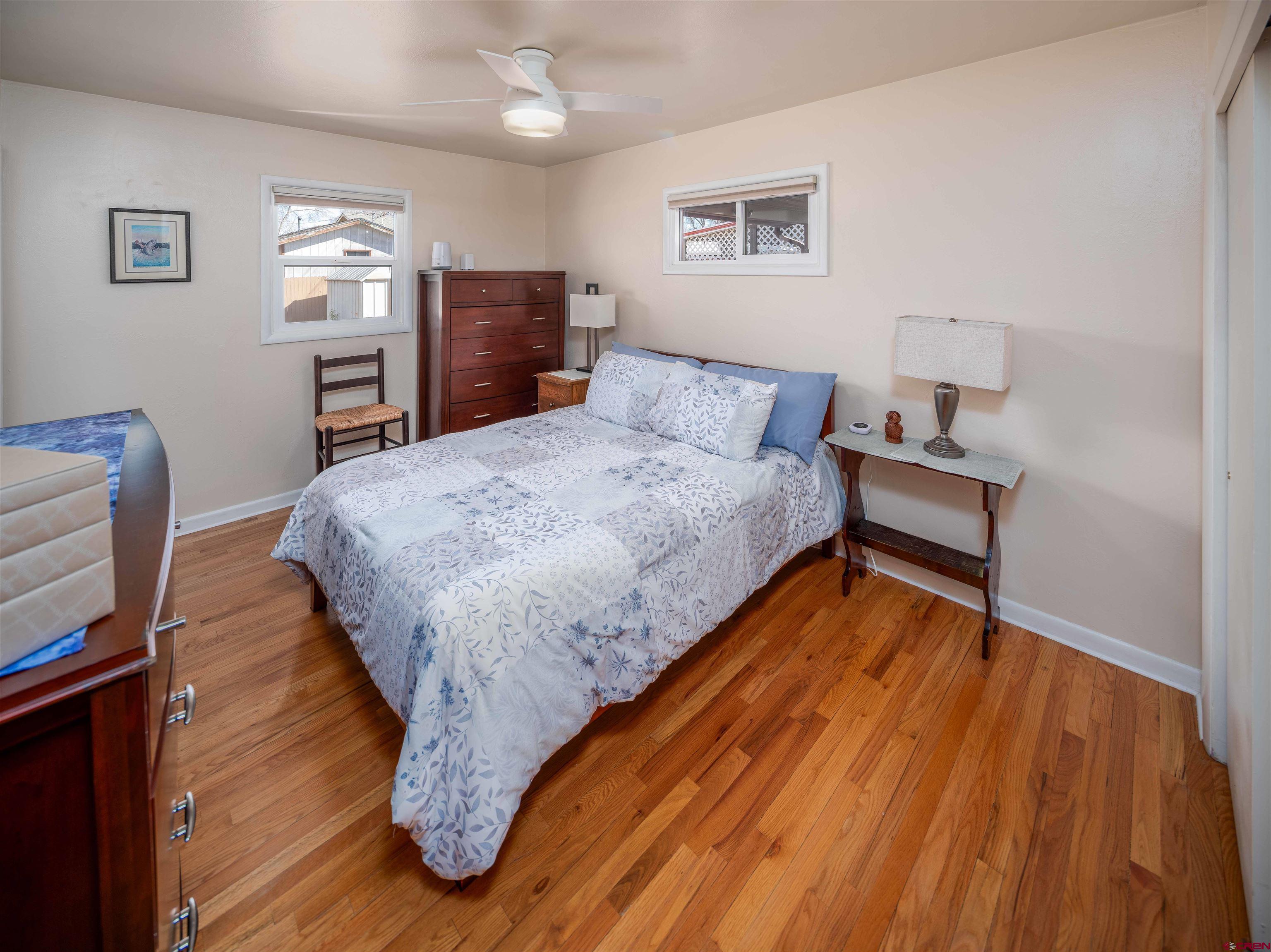 710 Wedgewood Street Cortez, CO 81321 - Photo 18 of 30 a bed sitting in a bedroom and wooden floor