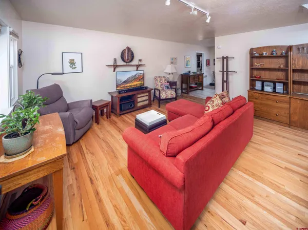 a living room with furniture and wooden floor