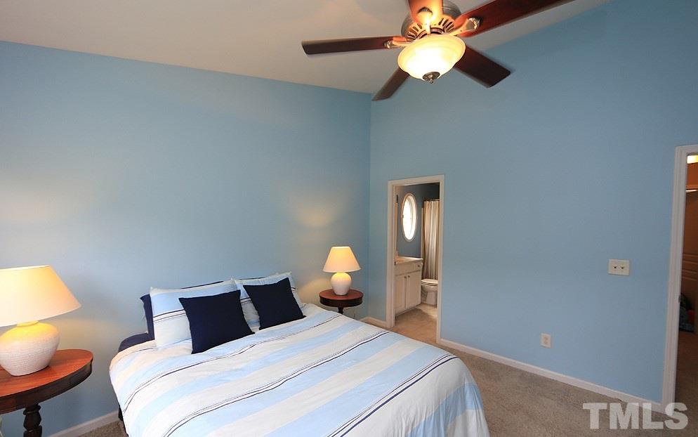 3715 Ramblewood Avenue Durham, NC 27713 - Photo 14 of 22 a bedroom with a bed and a chandelier