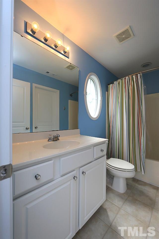 3715 Ramblewood Avenue Durham, NC 27713 - Photo 16 of 22 a bathroom with a sink a toilet and a mirror