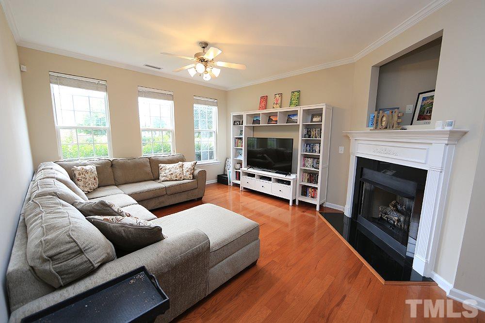 3715 Ramblewood Avenue Durham, NC 27713 - Photo 5 of 22 a living room with furniture a flat screen tv and a fireplace