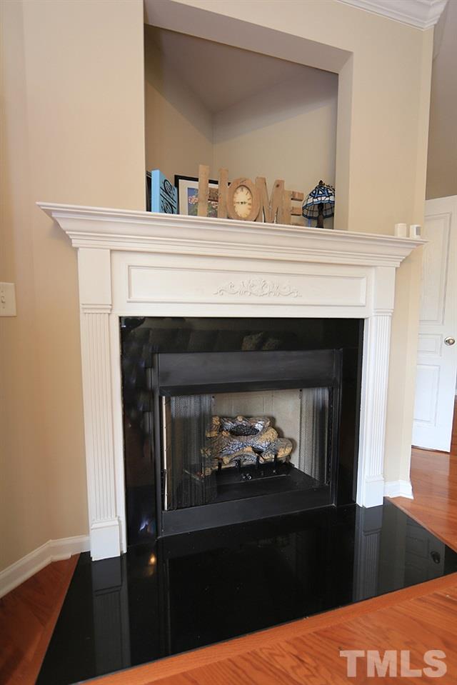 3715 Ramblewood Avenue Durham, NC 27713 - Photo 7 of 22 a close view of a fireplace with wooden floor