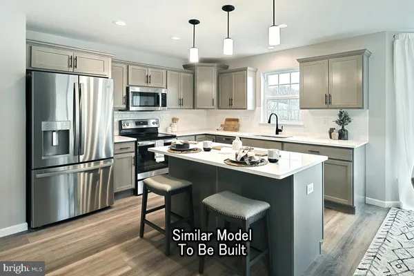 a kitchen with kitchen island a sink stove and refrigerator