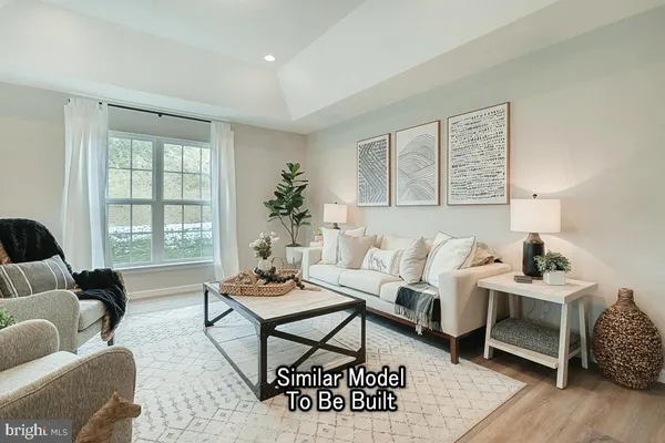 a living room with furniture wooden floor and a window