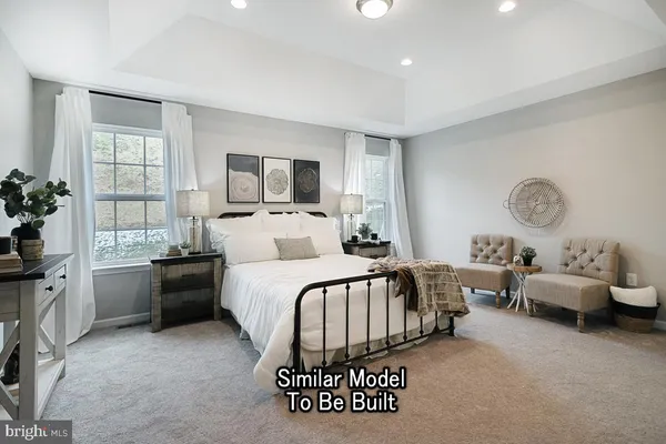 a bedroom with a bed and glass door