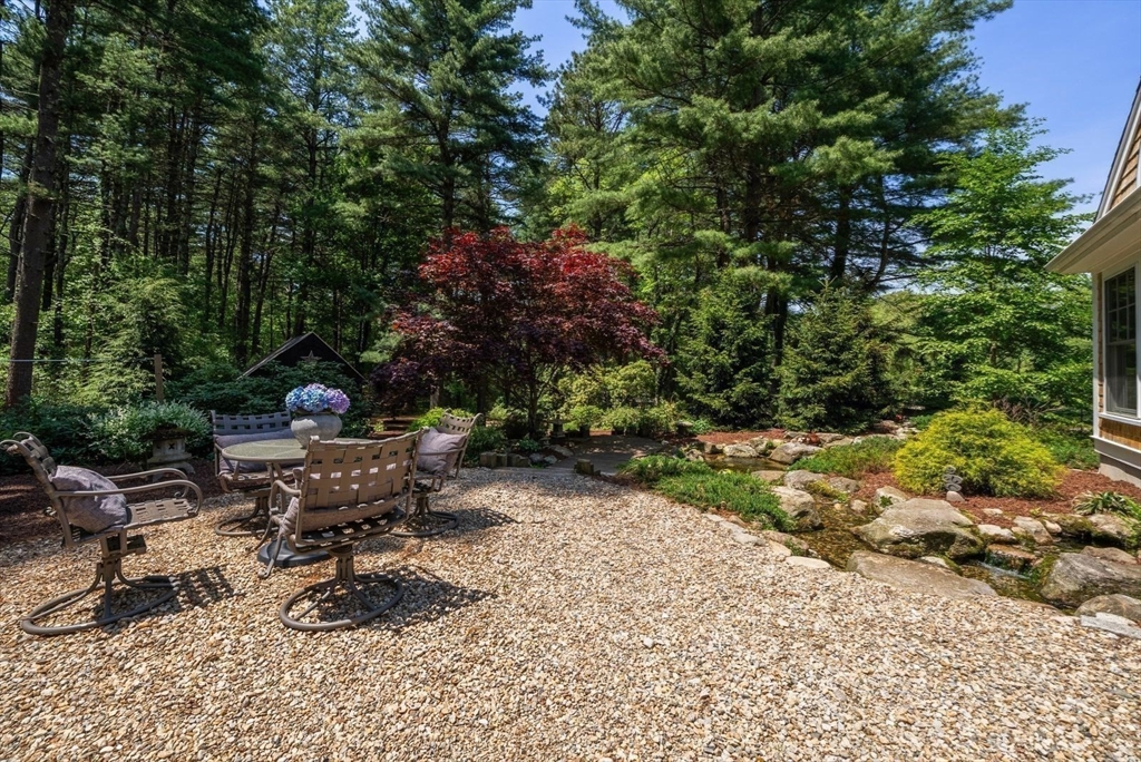 49 Walpole Street Dover, MA 02030 - Photo 32 of 40 a view of swimming pool with chairs and a fire pit
