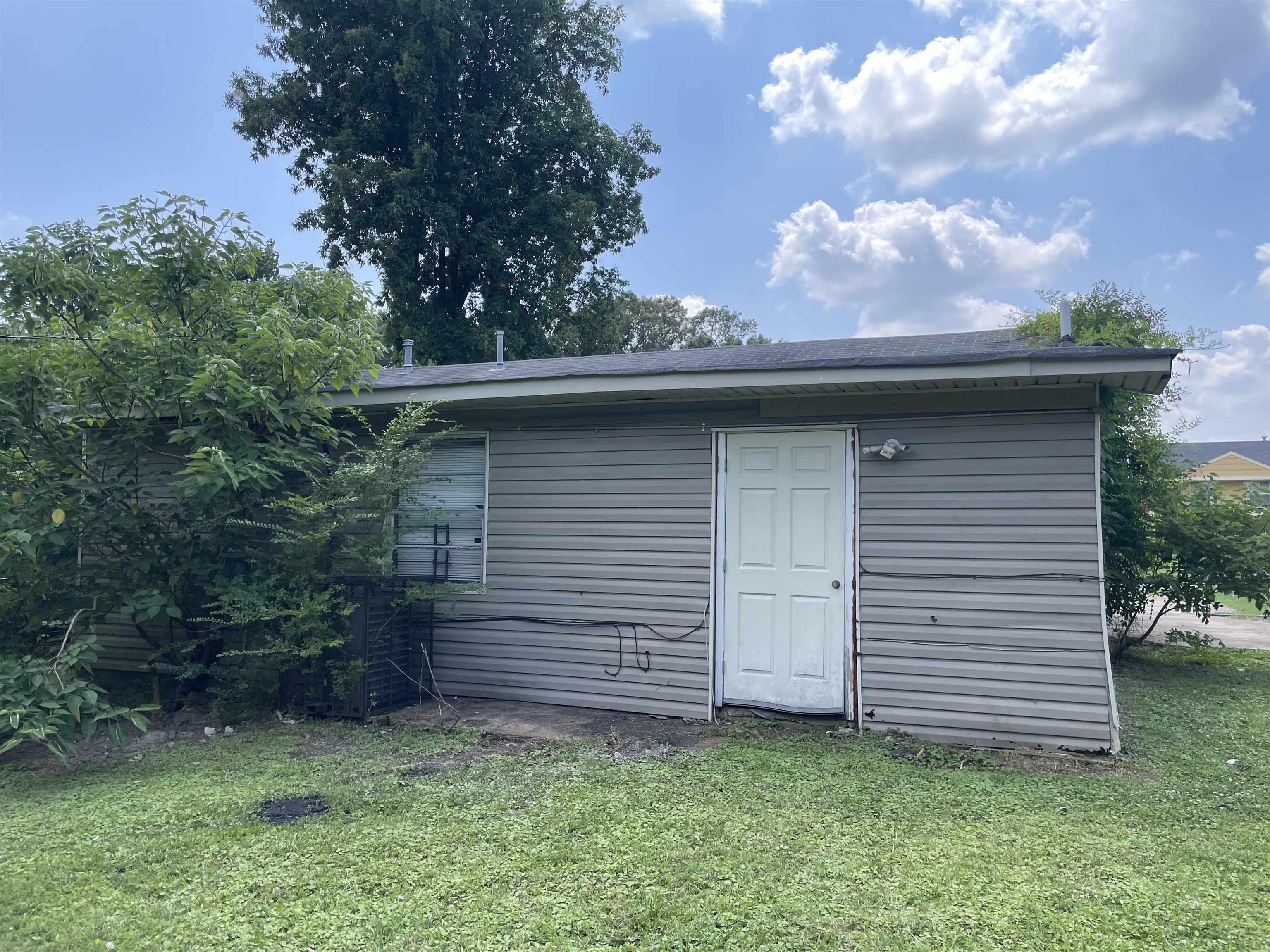 4448 Bluebell Street Memphis, TN 38109 - Photo 2 of 18 a view of a house with a yard