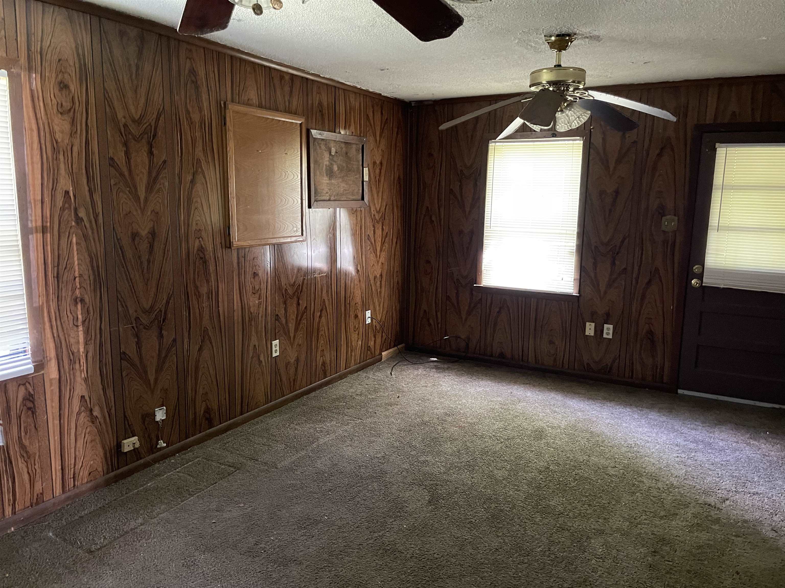 4448 Bluebell Street Memphis, TN 38109 - Photo 8 of 18 an empty room with windows closet and front door