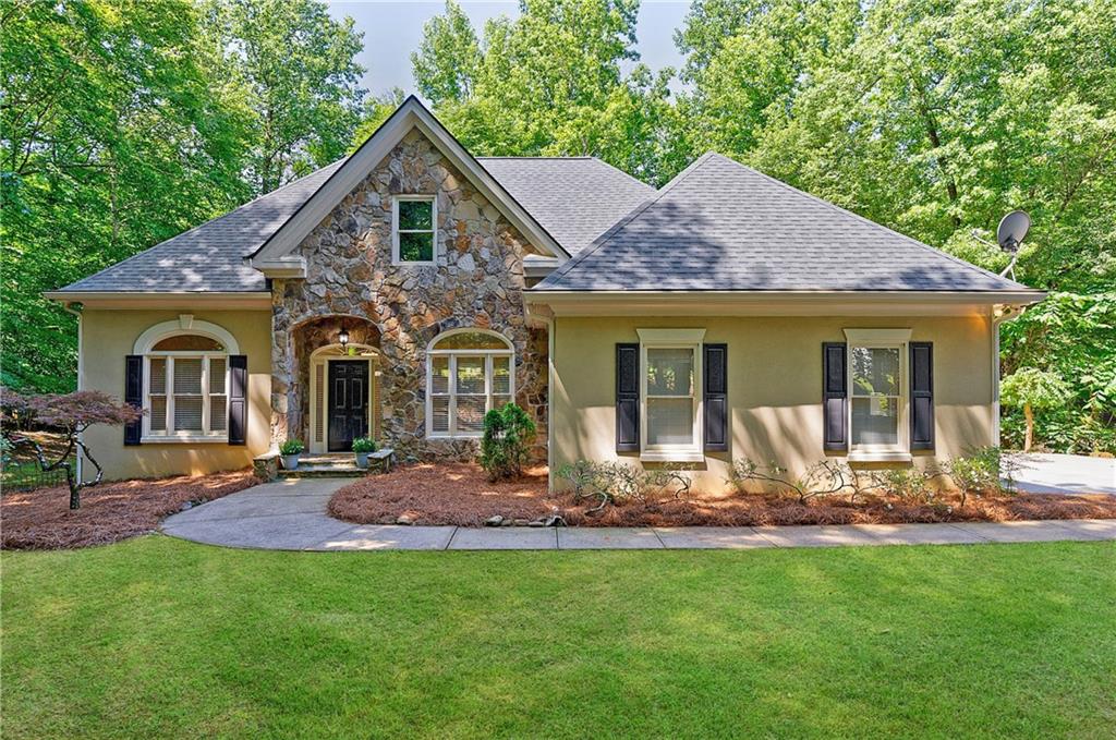 a front view of house with yard outdoor seating and green space
