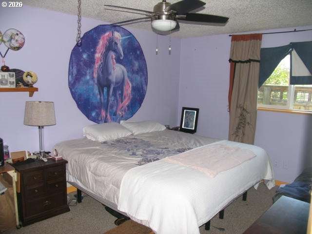 35 Northeast 157th Avenue Portland, OR 97230 - Photo 9 of 30 a bedroom with a bed and a chandelier