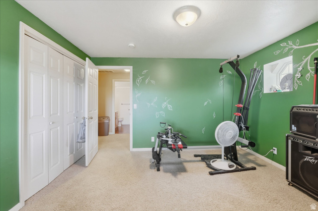 2887 View Crest Circle North Logan, UT 84341 - Photo 32 of 37 Workout area featuring light carpet and baseboards