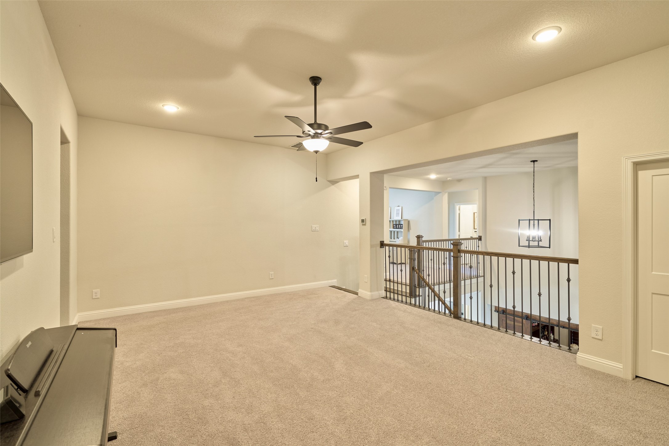 10090 South Goshawk Trail Conroe, TX 77385 - Photo 26 of 43 Game room on second floor with view to landing. Three bedrooms on this floor with one to the left with en-suite bath, two more are are opposite side near landing one with en-suite bath and the other with bath just outside the bedroom.