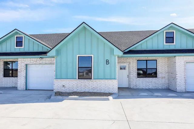 a front view of a house with garage