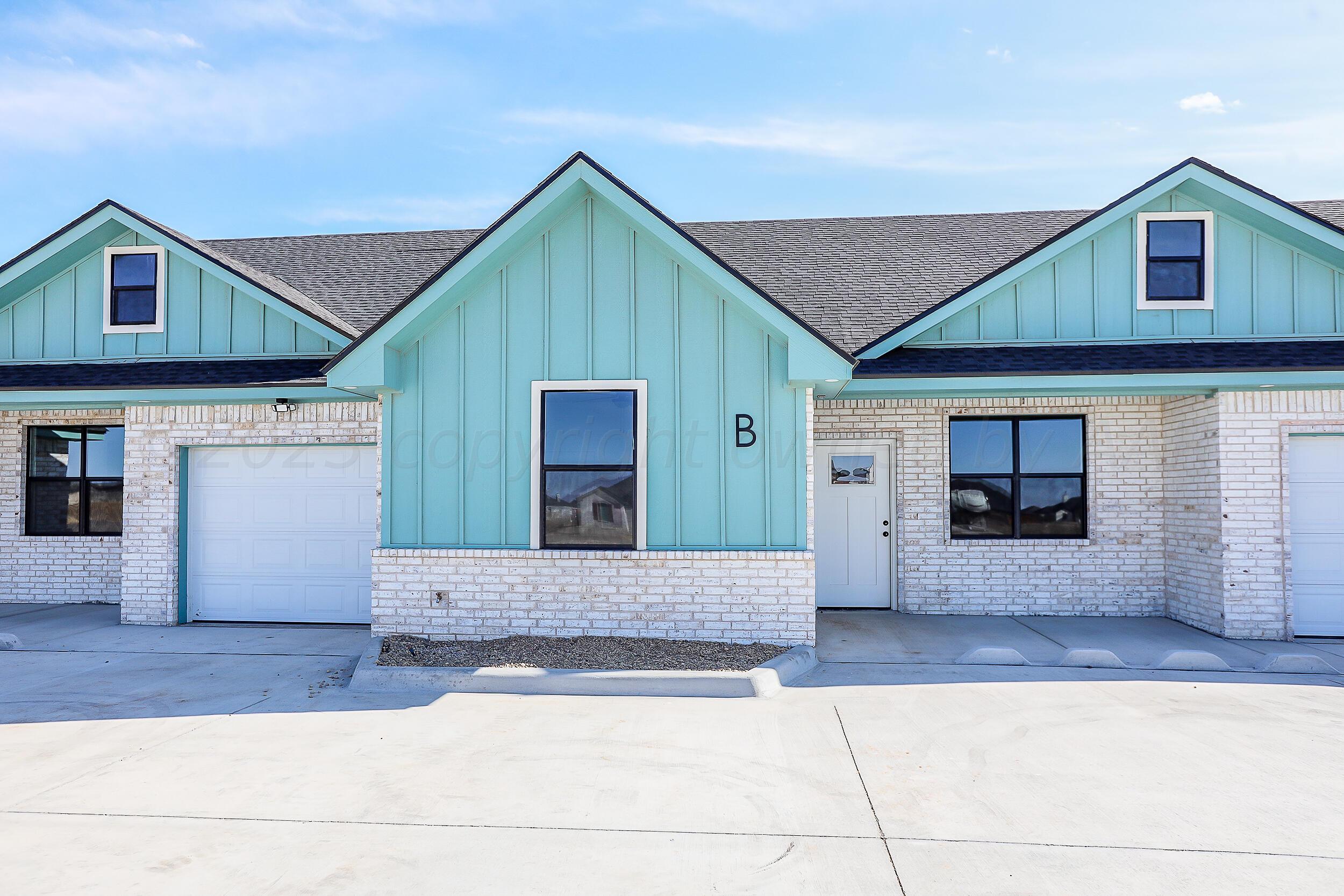 a front view of a house with garage