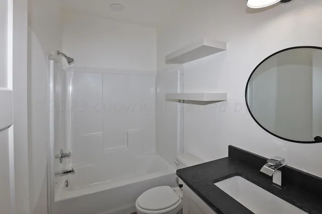 a bathroom with a glass shower door