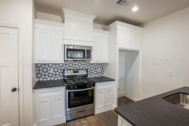 a kitchen with a stove and a microwave