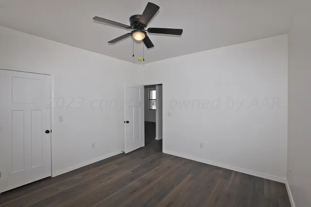 a kitchen with a refrigerator and white cabinets