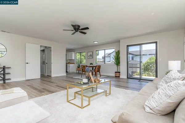 a living room with furniture and floor to ceiling window