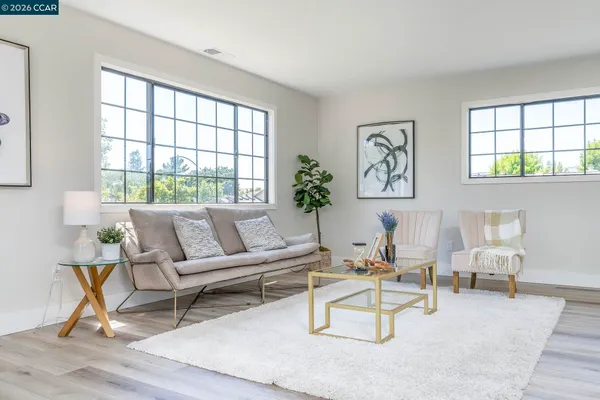 a view of living room filled with furniture and a window