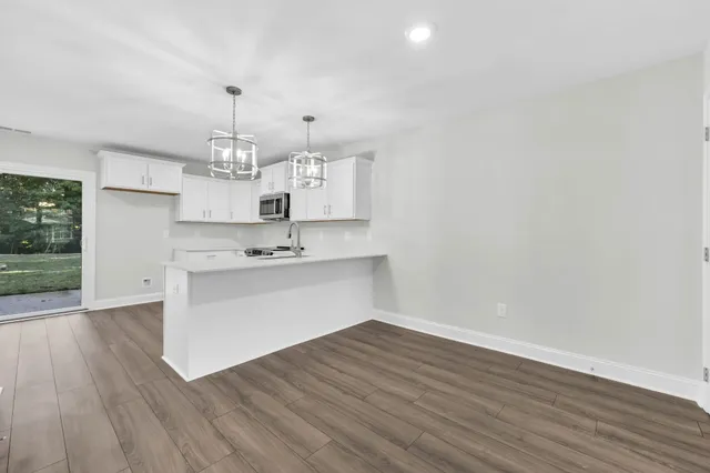 a view of kitchen cabinets and wooden floor