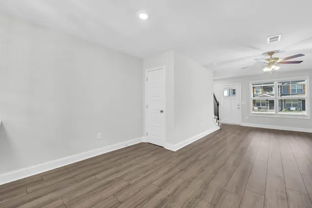 wooden floor in an empty room with a window