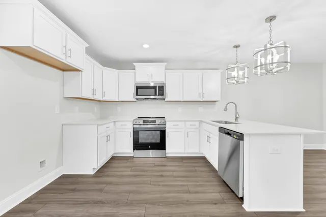 a kitchen with stainless steel appliances granite countertop a sink and stove top oven