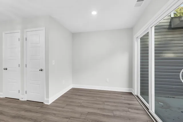 a view of wooden floor and windows in a room