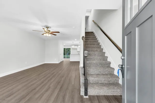 a view of entryway and hall with wooden floor