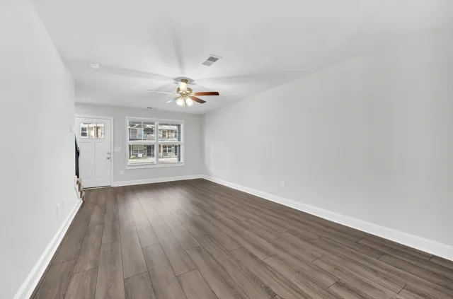 wooden floor in an empty room with a window