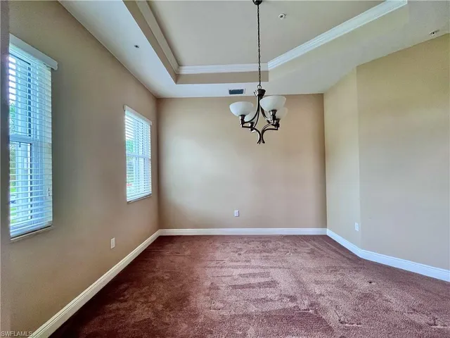 a view of a room with a window and a ceiling fan