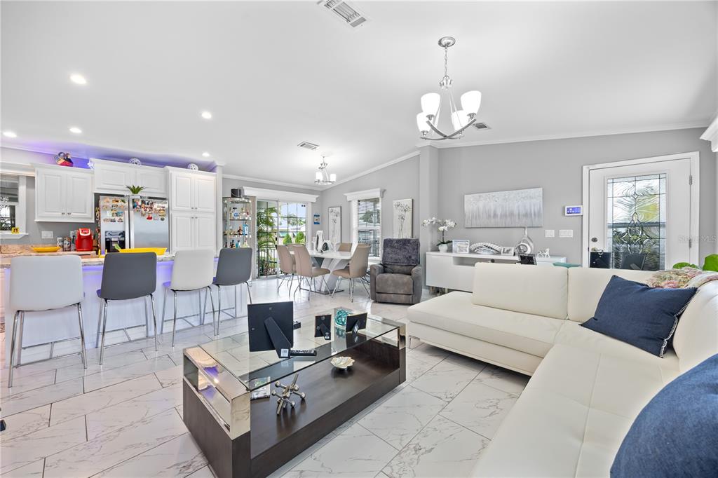 1890 Southwest 83rd Terrace Davie, FL 33324 - Photo 11 of 46 a living room with furniture a dining table and a chandelier