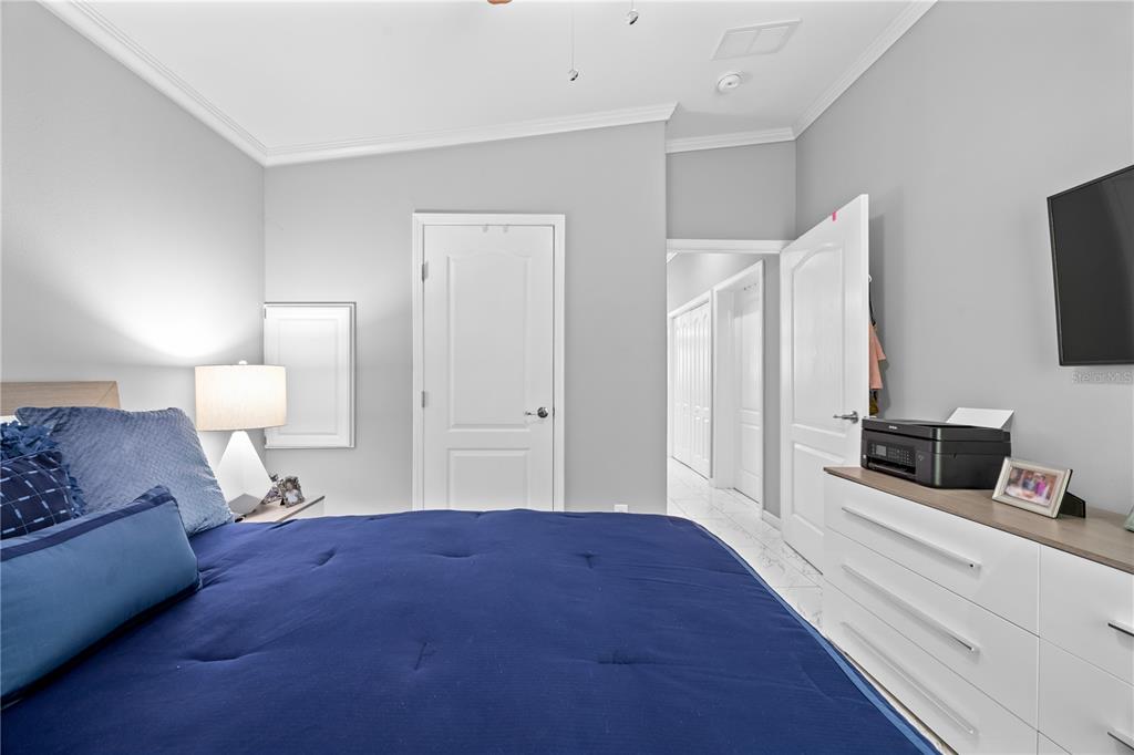 1890 Southwest 83rd Terrace Davie, FL 33324 - Photo 14 of 46 a bedroom with a bed and a flat tv screen on a dresser