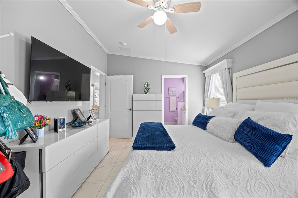 1890 Southwest 83rd Terrace Davie, FL 33324 - Photo 17 of 46 a bedroom with a bed and a flat screen tv