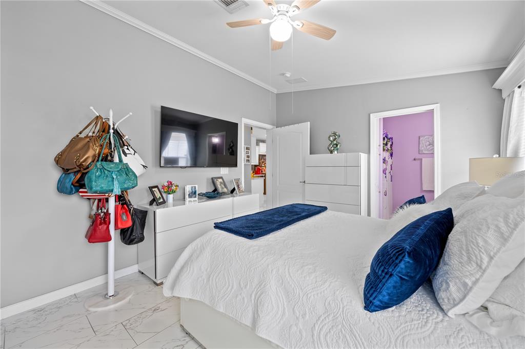 1890 Southwest 83rd Terrace Davie, FL 33324 - Photo 18 of 46 a bedroom with a bed and a chandelier