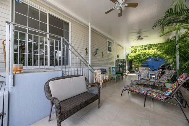 a balcony with furniture and a potted plant